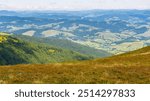 view in to the distant rural valley. mountainous countryside landscape. green meadows and forested hills. beautiful nature scenery of carpathians