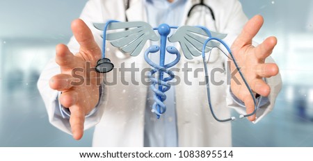 View of a Doctor holding a 3d redering medical cadaceus and stethoscope