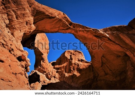 View of Double Arch - a close-set pair of natural arches in Arches National Park, it was formed as a pothole arch by water erosion from above (southern Grand County, Utah, United States)
