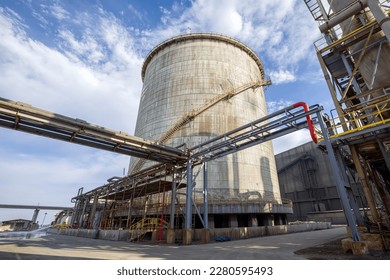 View the double walled  vertical  cylindrical ammonia storage tank   process piping in the industrial plant  In Fertilizers Industries surplus ammonia is stored in large capacity tank 	