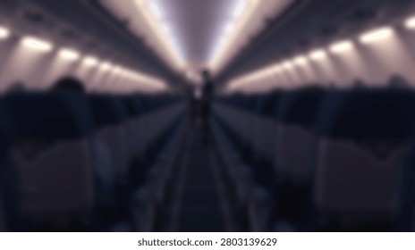 A view down the aisle of an empty airplane cabin, showing rows of dark seats and illuminated overhead lights creating a sense of perspective.