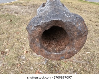 View down barrel of old rusty war cannon