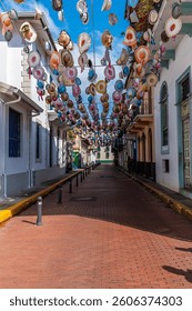 A view down a bright coloured and hat adorned street in old Panama City in the early morning in springtime
