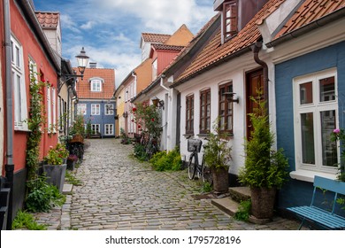 View down the cobblestone street of Hjelmerstald (Hjelmer stable), the historic preserved neighborhood of Aalborg, Denmark