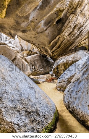 A view down into a rock chamber in the Baths National Park, Virgin Gorda in the British Virgin islands on a bright morning