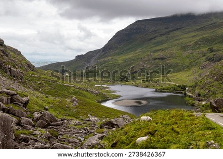 view down into the valley of Gap of Dunloe with the Auger Lake at a cloudy summer day in Kerry, Ireland