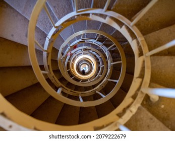 View down in Minaret tower to visitor going down by rotating stairs,  Lednice castle park. Shadows of tourists going down. Lednice, Czechia