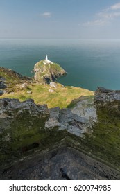 View down on South Stack light house on sunny morning from WWII coastal observation post South Stack. Anglesey, North Wales, United Kingdom.