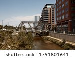View down path of Cherry Creek Trail along Platte River.  Surrounded by apartments and condominiums in Downtown Denver.  Denver, Colorado, USA