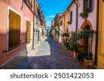 A view down a quiet, colourful street in the village area of San Giuliano in Rimini, Italy in summertime