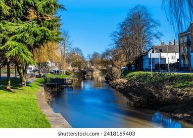 A view down the River Welland in the centre of Spalding, Lincolnshire on a bright sunny day