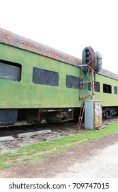 View Down The Side Of A Rusted Green Abandoned Railway Car And Train Track Light Fixture