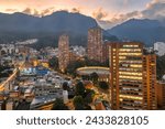 View of the downtown center in Santa Fe district, with Santamaria Bullring (Plaza de Toros), modern skyscrapers and Monserrate sanctuary in sunrise light, Bogota city, Colombia