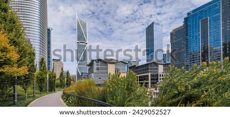 View of a downtown skyscrapers with trees and a path in a park in the SOMA neighborhood in San Francisco, California