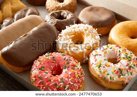 A view of a dozen donuts in a box.