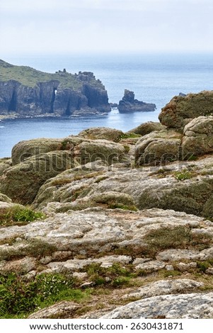 The view of Dr Syntax's Head through the bare rocks on the foreground. Land's End. Penwith peninsula. Cornwall. England. Great Britain