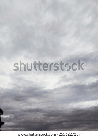 View of a dramatic overcast sky filled with gray clouds, creating a gloomy atmosphere.