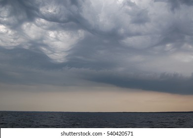 A view of dramatic thunderstorm clouds forming over sea. 