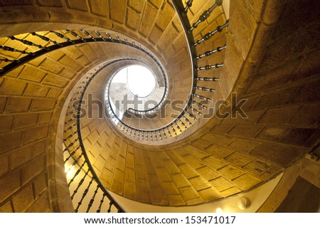 View up a dramatic triple spiral staircase.