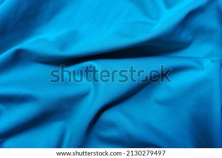 View of draped cerulean blue polyester fabric from above