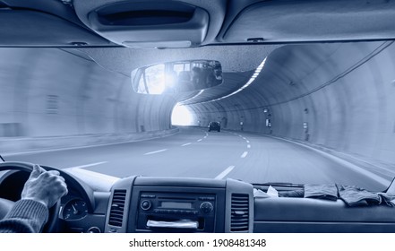 A view from the driver's angle to car interior with long tunnel