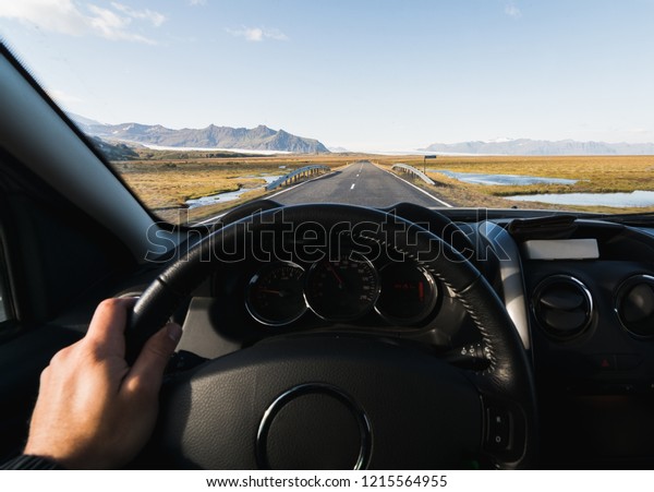 View from driver\'s seat over the coastal road at\
the South of Iceland.