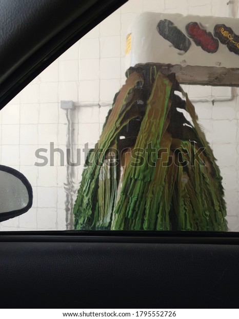 View of\
drive-through car wash, from car interior\
