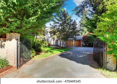 View Of Driveway With Opened Gate. Double Garage And Well Kept Garden. Northwest, USA