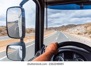 View from the driving position of a truck of the rearview mirror and the empty highway. - Powered by Shutterstock