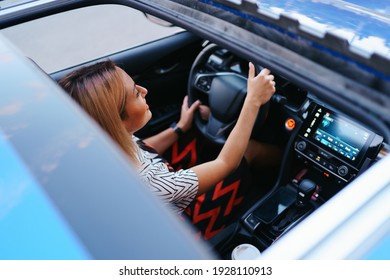 View Of A Driving Woman Through Sunroof