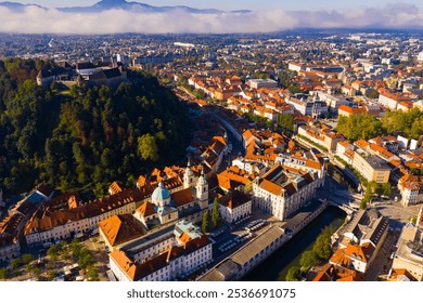 View from drone of historical center of Slovenian city of Ljubljana with medieval castle on Castle Hill in autumn morning - Powered by Shutterstock