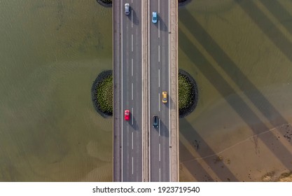 View From A Drone Looking Down On Traffic On A Road Bridge Crossing A Large River In Suffolk, UK