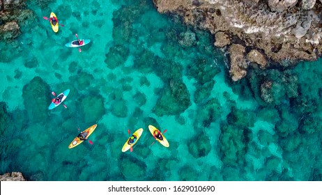 
view of a drone from a drone people are kayaking in the sea near the mountains in a cave with turquoise water on the island of Cyprus Ayia Napa - Powered by Shutterstock