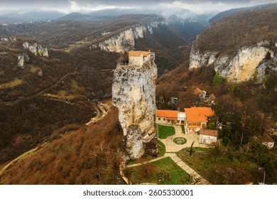 View from drone of small monastery complex with chapel on top of high rock formation of Katskhi Pillar in Imereti region of Georgia.