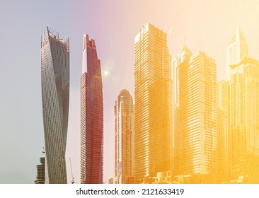 View Of Dubai Marina Towers. View of high-rise buildings of residential district in Dubai Marina is district in Dubai, United Arab Emirates in sunny day. Urban background. Flare sun, film effect, lens