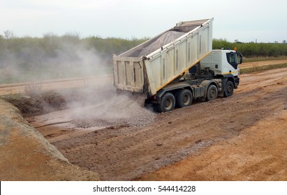 View Of Dump Truck Dumping Gravel