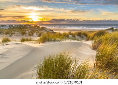 View from dune top over sunset in North Sea from the island of Ameland, Friesland, Netherlands - Shutterstock ID 1721879131