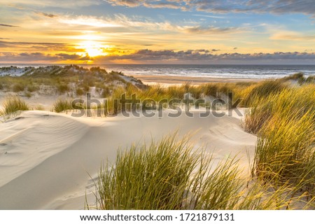 View from dune top over sunset in North Sea from the island of Ameland, Friesland, Netherlands