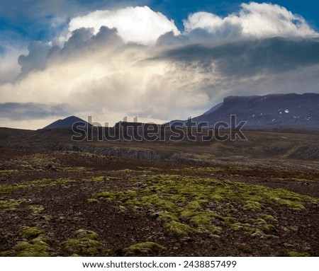 View during auto trip in West Iceland highlands, Snaefellsnes peninsula, Snaefellsjokull National Park. Spectacular volcanic tundra landscape with mountains, craters, lakes, gravel roads.