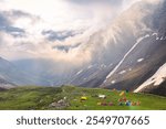 View during sunrise from Rupin pass trek campsite in alpine meadows of Himalayas. This trek is full of diversity from majestic Himalayan ranges to waterfalls, glacial meadows.