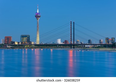 View Of Dusseldorf Over The Rhine River In A Summer Night