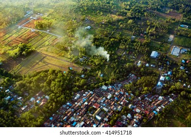 View Of The Earth Landscape, Manado City, From An Airplane Above The Clouds, Indonesia