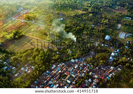 view of the earth landscape, Manado city, from an airplane above the clouds, Indonesia