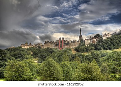 View of Edinburgh old city with the tower of the Parish Church of Saint Cuthbert above the trees of Princes Street Gardens