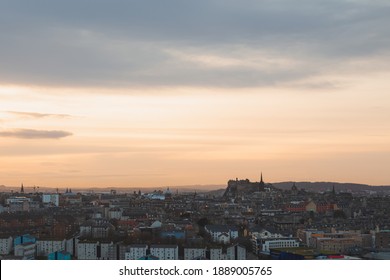 A View Of Edinburgh's Old Town Cityscape Skyline At Sunset Or Sunrise From Salisbury Crags.