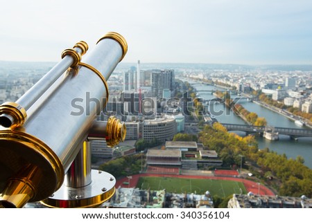 A view from the Eifel tower in Paris and a telescope by the left side