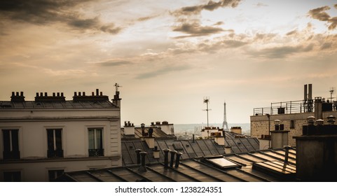 View of the Eiffel Tower above the rooftops of Paris in Montmartre - Powered by Shutterstock - Get 15% off with code: PIKWIZARD15