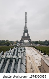 View of the Eiffel tower in Paris on a cloudy day. Famous touristic places and romantic travel destinations in Europe. Travel and tourism concept, France.