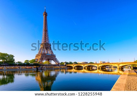 View of Eiffel Tower and river Seine at sunrise in Paris, France. Eiffel Tower is one of the most iconic landmarks of Paris