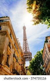 
View Of The Eiffel Tower From A Street Of Paris In A Sunny Summer Day. Flare Because Of The Sun 